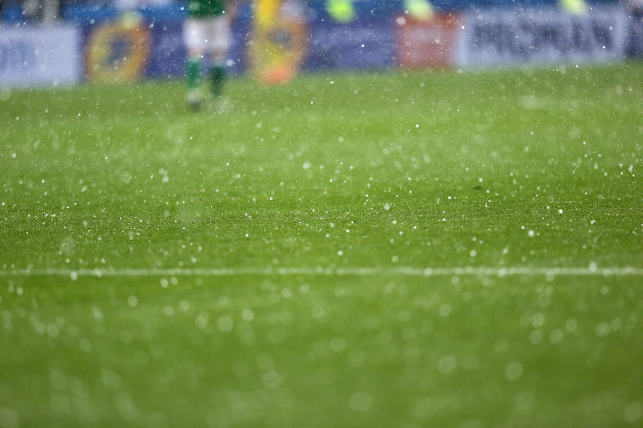 Green football field during rain showers