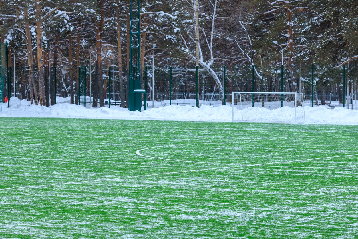 empty football pitch with snow ploughed to the side